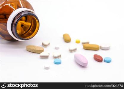 Difference tablets pills heap mix isolated on white background.