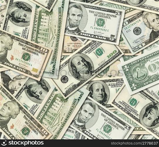 Different American Dollar bills banknotes piled together.