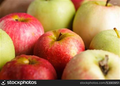 Different apples on wooden table in garden