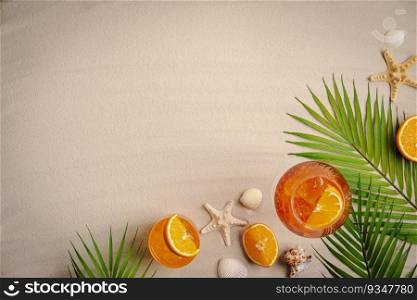 Different beach accessories, palm leaves, seashells and glass of aperol cocktail on sand, top view, flat lay. Space for text. Summer beach background