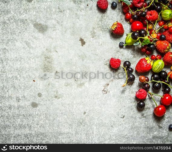 Different berries on the old stone table.. Different berries on the stone table.