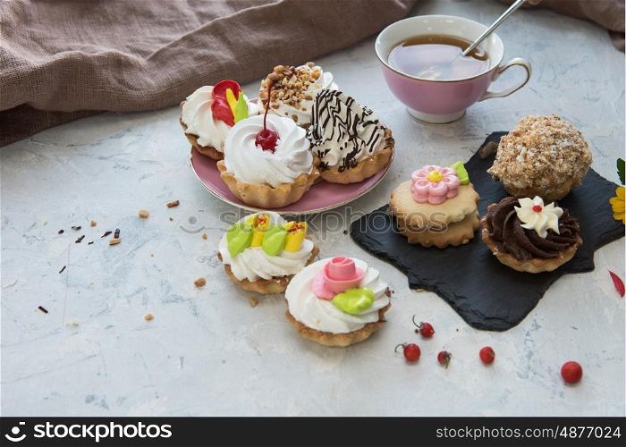 Different cakes composition. Different cakes composition on concrete background
