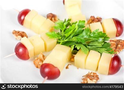 different cheese and grapes and nuts close up composition