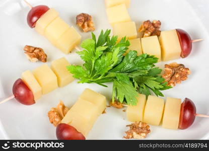 different cheese and grapes and nuts close up composition