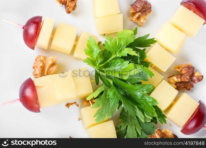 different cheese and grapes and nuts close up composition