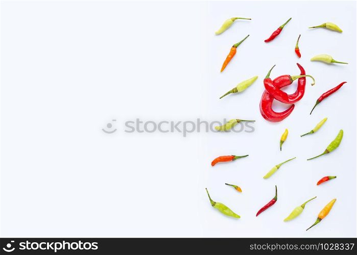 Different chili on white background. Copy space