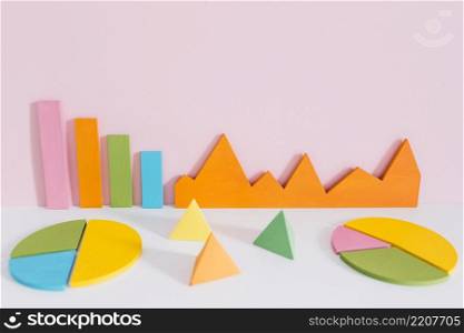 different colorful graph with pyramid shapes against pink background