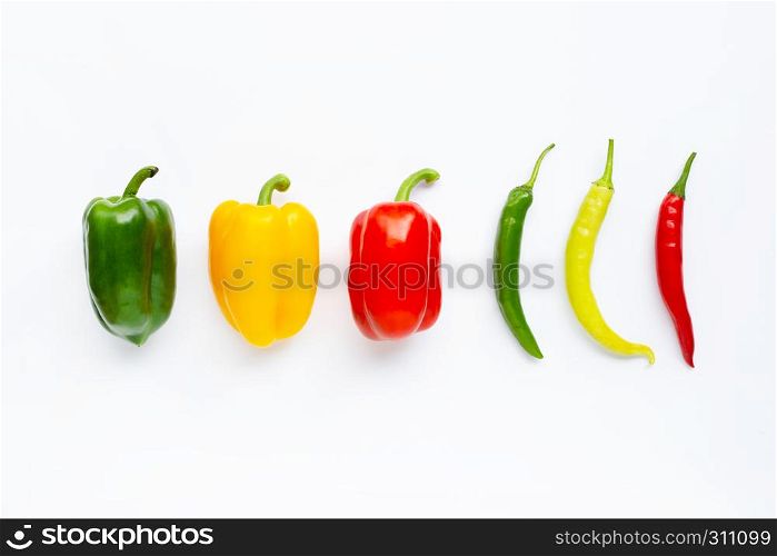Different colors bell peppers and chili peppers isolated on white background