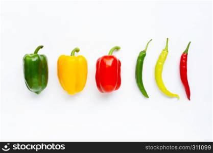Different colors bell peppers and chili peppers isolated on white background