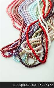 Different colors of beads necklace closeup background. Necklace palette close up