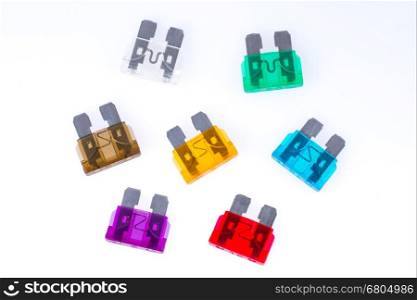 Different colors of car fuses with a white background