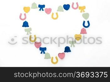 different coloured confetti in shape of heart on white background