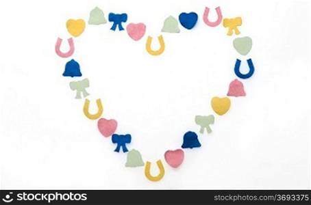 different coloured confetti in shape of heart on white background