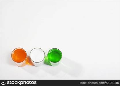 Different coloured paints in a glass