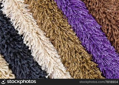 different colourful artificial shaggy carpet samples, closeup