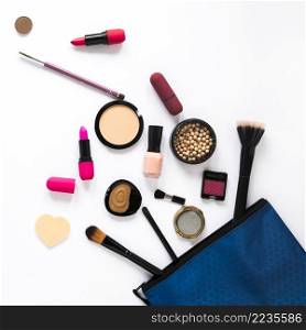 different cosmetics scattered from beauty bag table