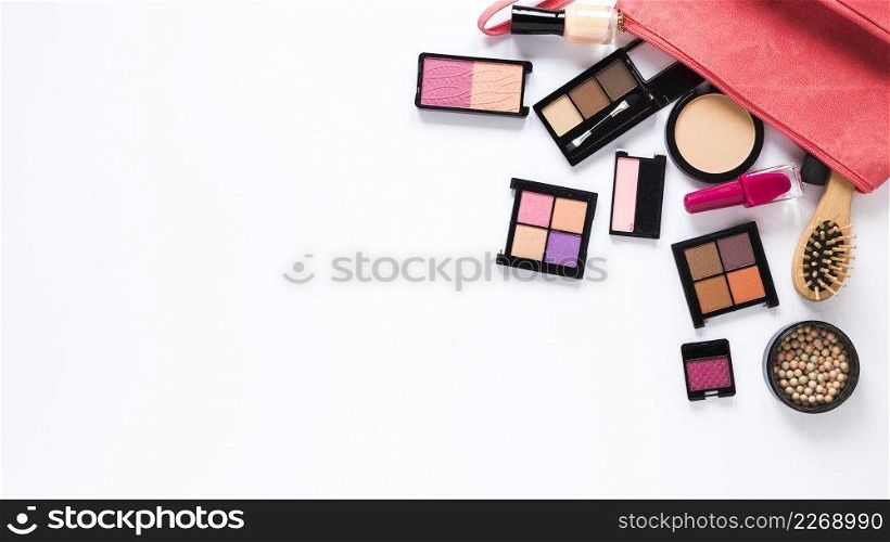 different cosmetics types scattered white table