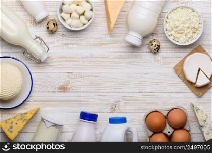 Different dairy products on white wooden table flat lay top view frame composition with copy space