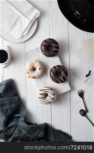 Different donuts on wooden table.