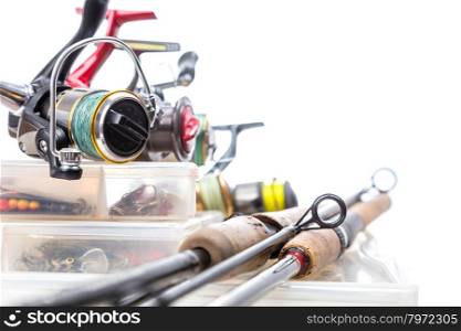 different fishing reels and rods on storage boxes with fishing baits and lures