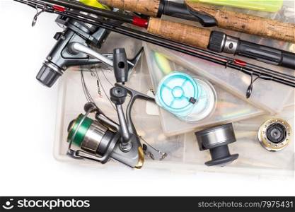 different fishing tackles - rod, reel, line and lures in box on white background