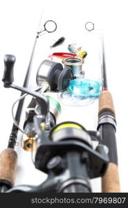 different fishing tackles - rod, reel, line and lures on white background