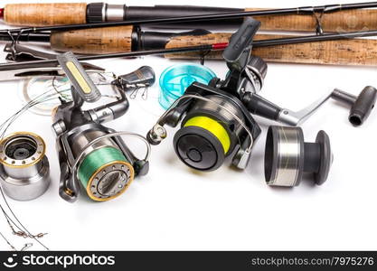 different fishing tackles - rod, reel, line and lures on white background