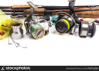 different fishing tackles - rod, reel, line and lures on white background