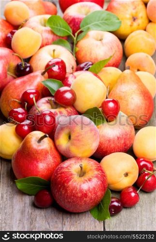 different fresh fruits and berries on wooden table