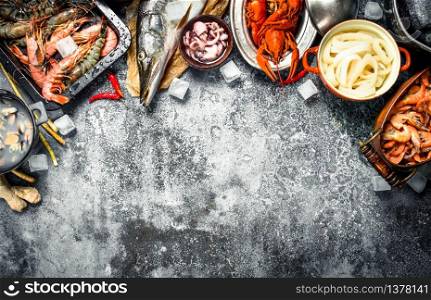 Different fresh seafood. On a rustic background.. Different fresh seafood.
