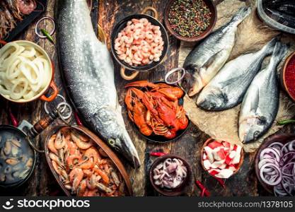 Different fresh seafood. On a wooden background.. Different fresh seafood.