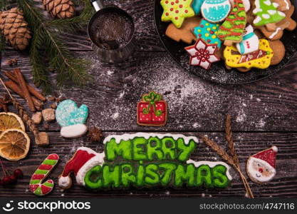 Different ginger cookies and coffee for new years and christmas on wooden background, xmas theme. Top view.