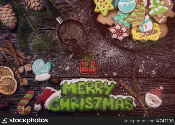 Different ginger cookies and coffee for new years and christmas on wooden background, xmas theme. Top view.