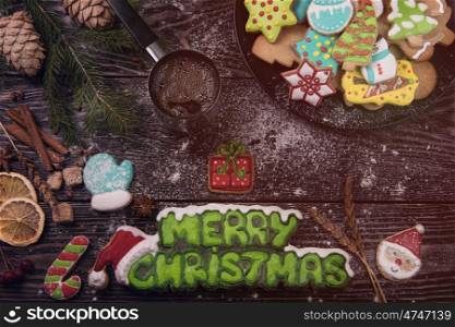Different ginger cookies and coffee for new years and christmas on wooden background, xmas theme. Top view.