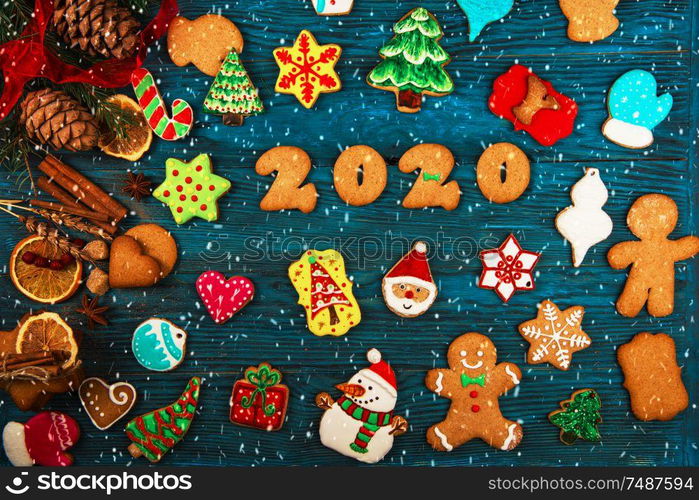 Different ginger cookies for 2020 New Year holiday on wooden background, xmas theme. Different ginger cookies 2020 year