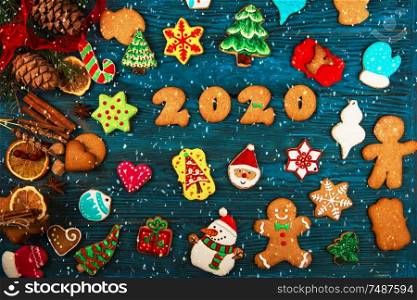 Different ginger cookies for 2020 New Year holiday on wooden background, xmas theme. Different ginger cookies 2020 year