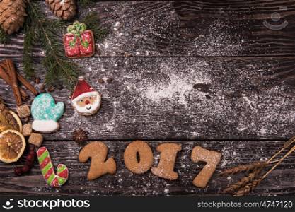 Different ginger cookies for new 2017 year holiday on wooden background, xmas theme