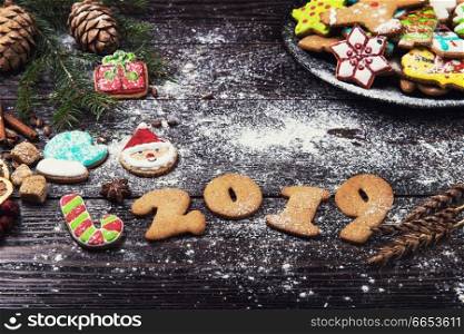 Different ginger cookies for new 2019 year holiday on wooden background, xmas theme. Different ginger cookies 2019 year