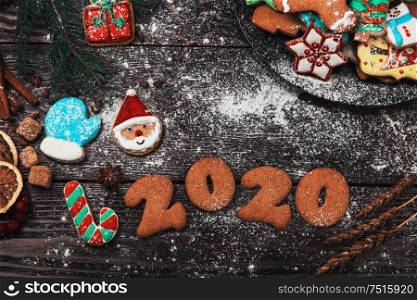 Different ginger cookies for new 2020 year holiday on wooden background, xmas theme. Different ginger cookies 2020 year