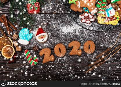 Different ginger cookies for new 2020year holiday on wooden background, xmas theme. Different ginger cookies 2020 year