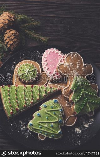 Different ginger cookies for new years and christmas on plate, closeup, toned photo
