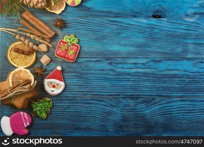 Different ginger cookies for new years and christmas on wooden background, top view with space for design