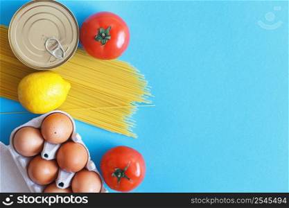 Different healthy food products on a blue background. Top view. Flat lay. Grocery online shop background. Different healthy food products on a blue background. Top view. fruit, vegetable, eggs and grocery online shop.your text