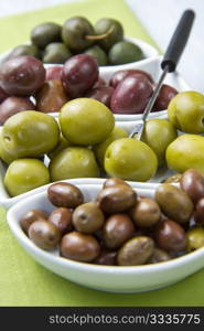 different kind of olives on wooden table