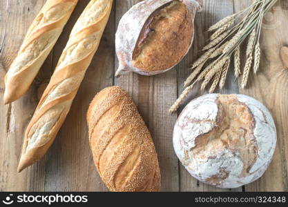 Different kinds of bread on the wooden background