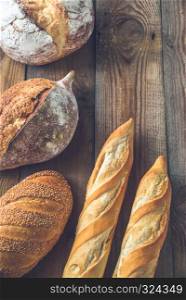 Different kinds of bread on the wooden background