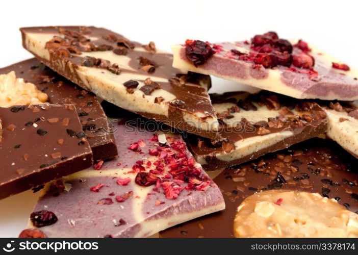 Different Kinds of Broken Chocolate Bars on White Background