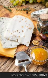 Different kinds of cheeses. Different types of cheese on rustic wooden table
