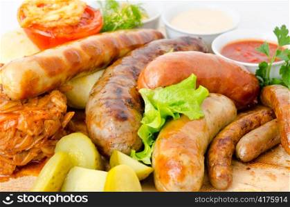 different kinds of grilled sausages with different sauces