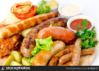 different kinds of grilled sausages with different sauces